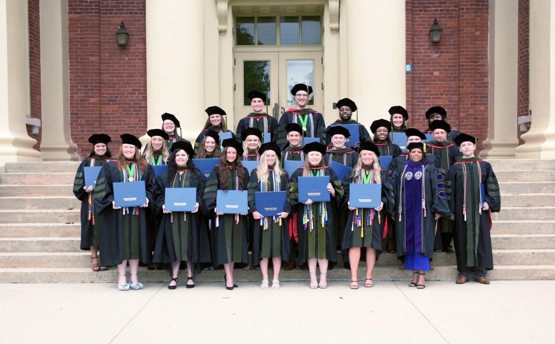 Presbyterian College School of Pharmacy Class of 2025 Graduates on the stairs in front of Neville Hall